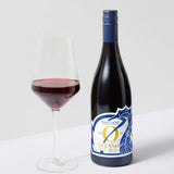 2024 Pinot Noir — beside a poured glass