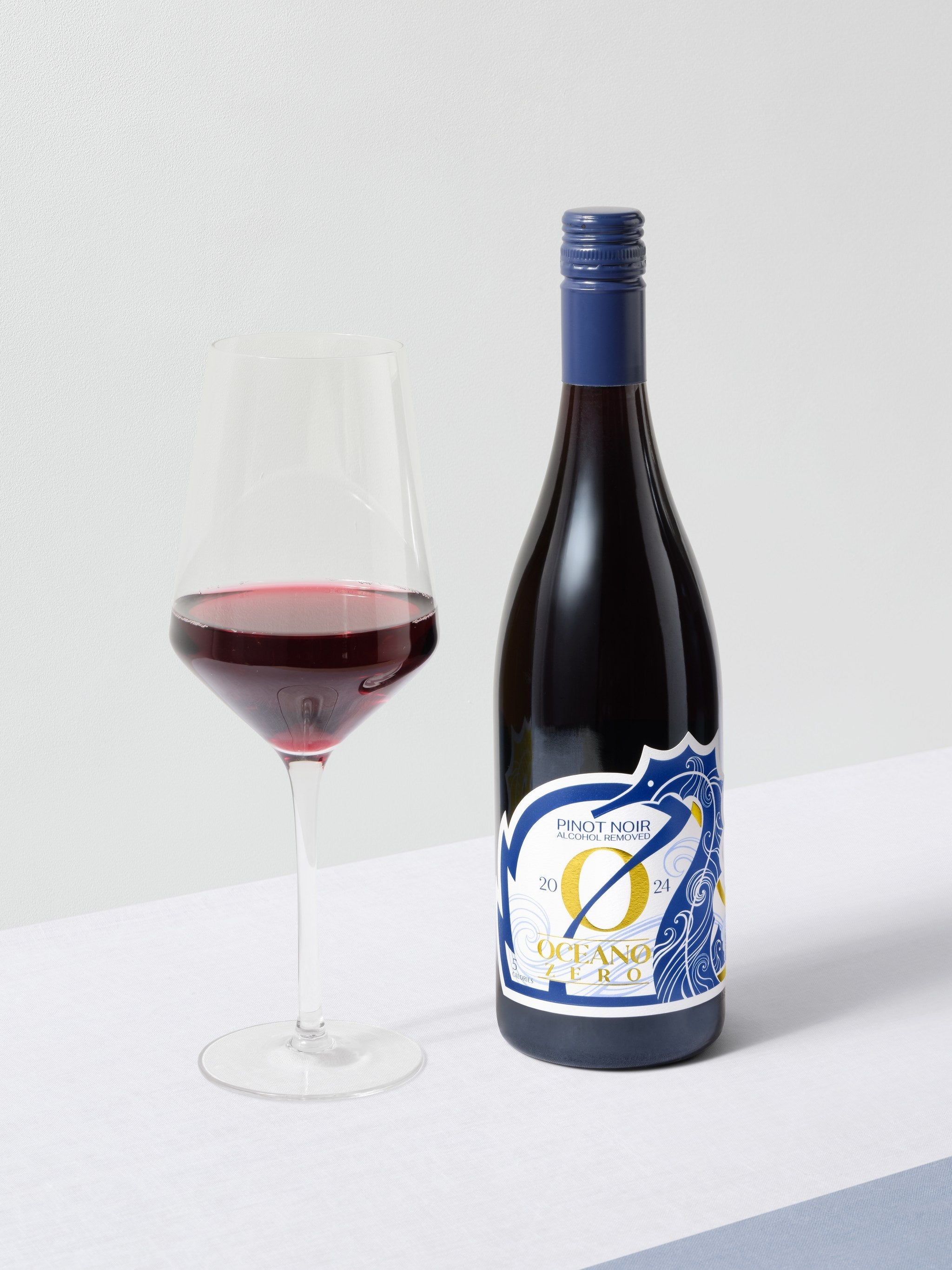 2024 Pinot Noir — beside a poured glass